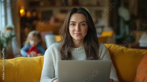 Professional photo of a woman sitting on the sofa of her home with in front of a laptop while working from home