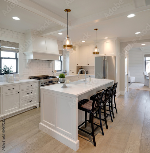 Bright white kitchen with island and three chairs, bathed in warm light, inviting for gatherings and culinary adventures at a traditional cottage.