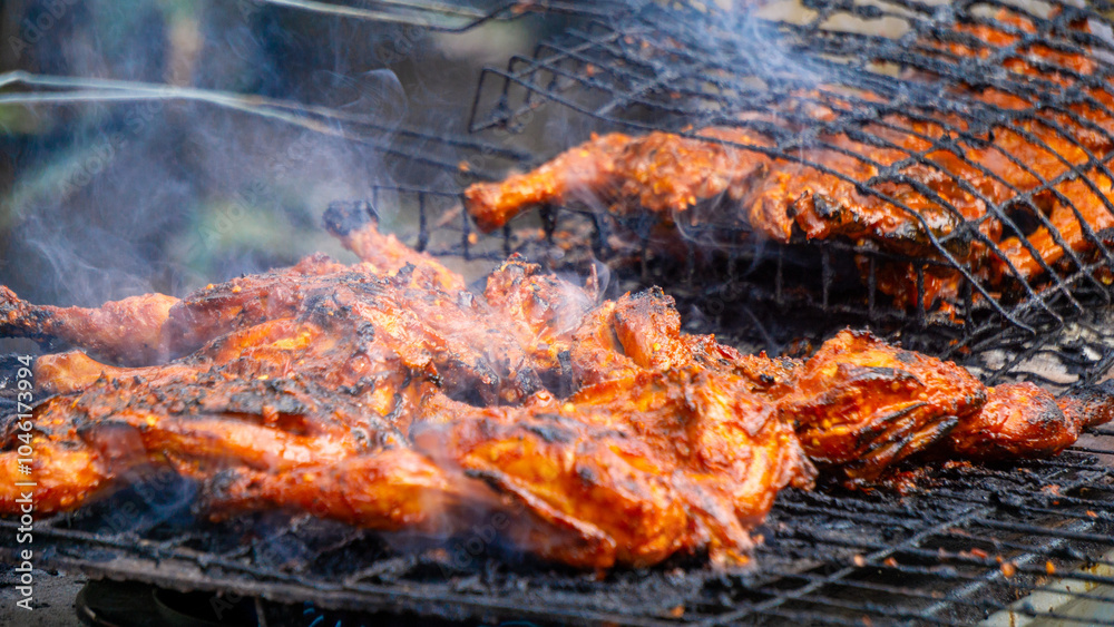 The seller roasted chicken with soy sauce, herbs and spice from Indonesia. Indonesian called this food with ayam bakar. The seller roasted chicken with soy sauce, herbs and spice from Indonesia. Indonesian called this food with ayam bakar.