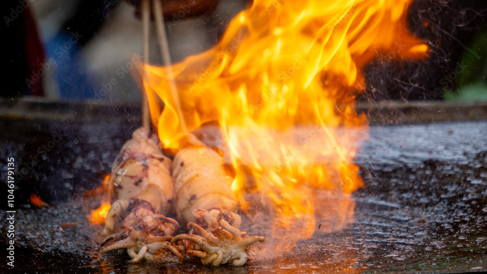 The seller roastedsquid with soy sauce, herbs and spice from Indonesia. Indonesian called this food with cumi bakar.
