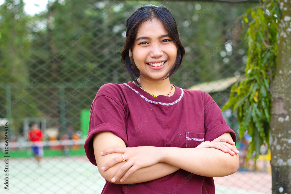 happy asian woman standing in tennis court with cross arms look at camera with confidence happy asian woman standing in tennis court with cross arms look at camera with confidence