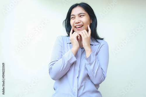 excited beauty asian young business woman touch her cheek and look aside to empty space with happiness smile, joyful and satisfaction expression female, wear formal suit, isolated in white background