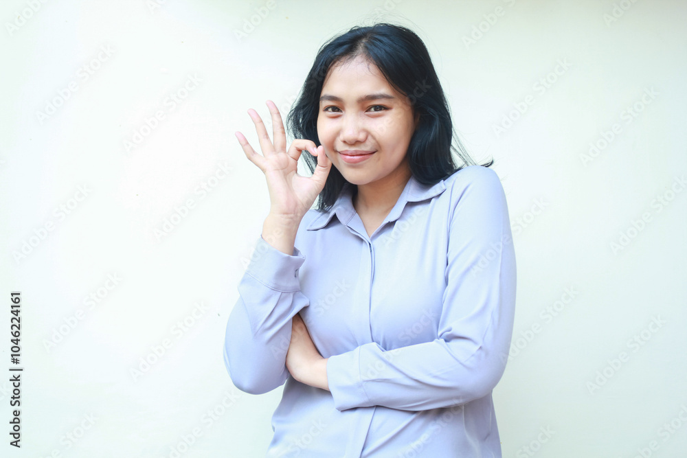 happy asian young business woman show ok sign perfection gesture look camera with confidence smile, folded arm female wear formal shirt isolated background happy asian young business woman show ok sign perfection gesture look camera with confidence smile, folded arm female wear formal shirt isolated background