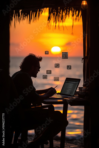 Silhouette of a person working on a laptop at sunset in a tropical paradise