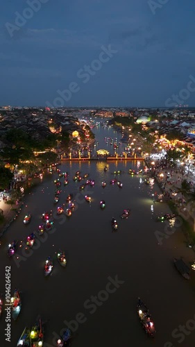 Panoramic aerial drone view of Hoi An Ancient town with boat tour and beautiful lanterns in evening. UNESCO world heritage. One of the most travel popular touristic destinations