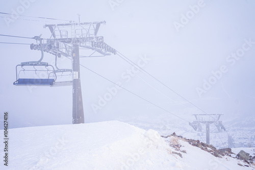 empty cable car in snowy fog