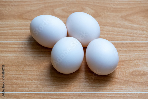 White chicken eggs on a wooden background. These eggs are naturally reared country chicken eggs in the village home of Bangladesh. photo