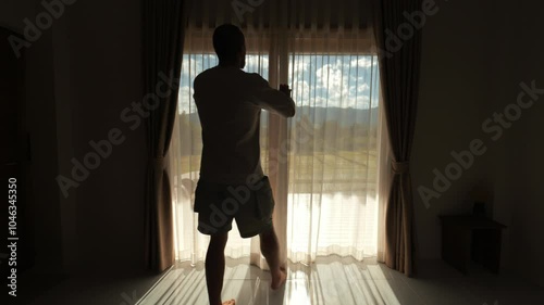 Handsome Athletic Man In Hotel Room Opens Curtains And Doors To Step Onto Terrace With Scenic Mountain And Rice Field View, Relaxing Morning In Northern Thailand Luxury Retreat