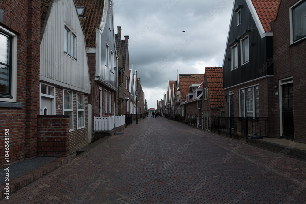 Fototapeta premium Walking on empty Zuideinde during slow afternoon in Volendam