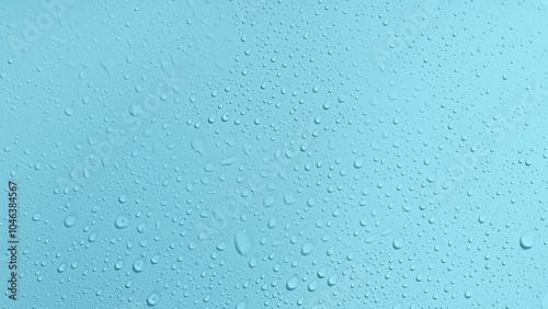 Rain drops of water on blue glass surface. Wet background with spray liquid bubbles. Fresh and cool background