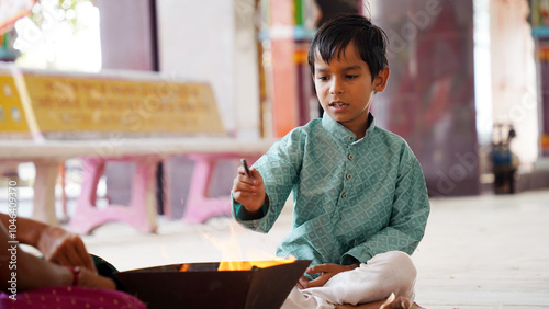 A Hindu family gathered around a sacred fire, performing a Yagya during a festival celebration photo