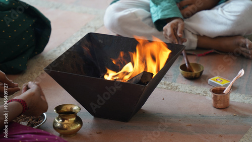 A Hindu family gathered around a sacred fire, performing a Yagya during a festival celebration photo