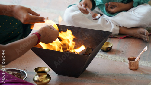 A Hindu family gathered around a sacred fire, performing a Yagya during a festival celebration photo