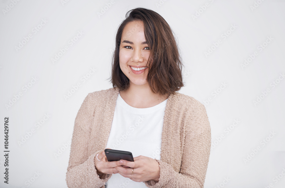 Portrait, smile and woman with smartphone, typing and mobile user on white studio background. Face, person and model with cellphone, communication or network with social media, message or digital app Portrait, smile and woman with smartphone, typing and mobile user on white studio background. Face, person and model with cellphone, communication or network with social media, message or digital app