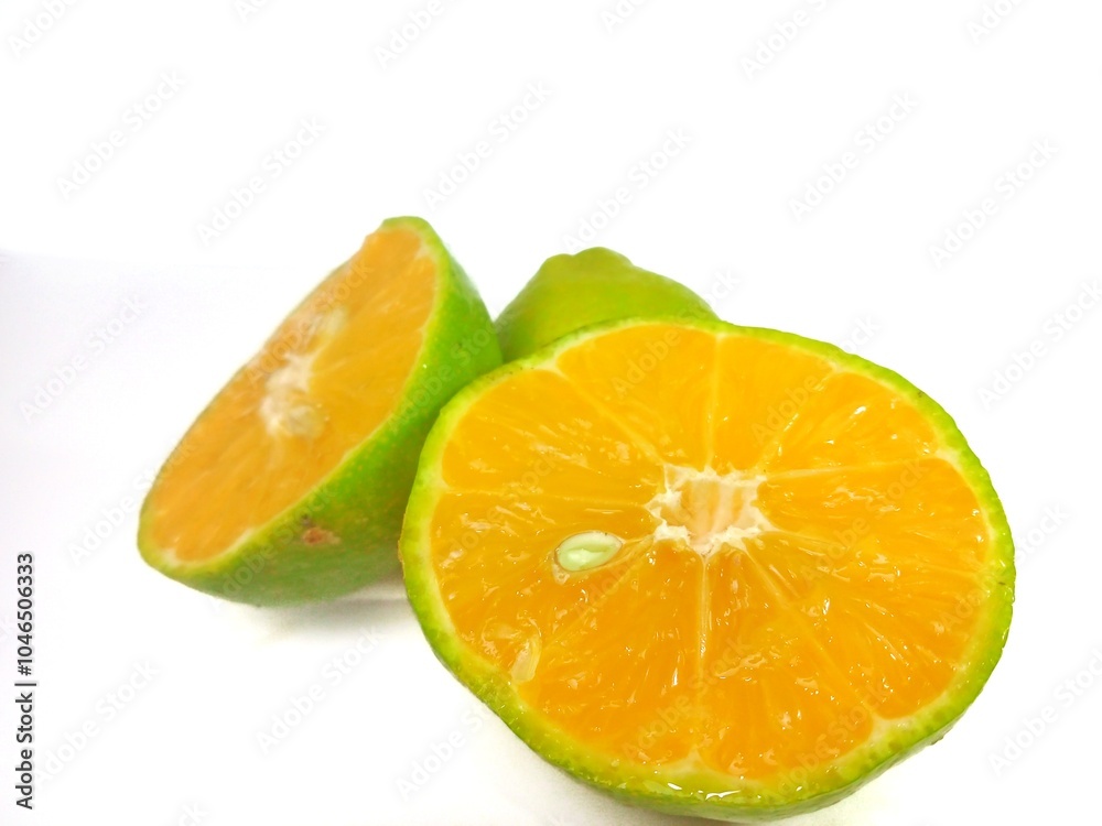 Lemon and slice isolated on white background. orange peel is green Lemon and slice isolated on white background. orange peel is green