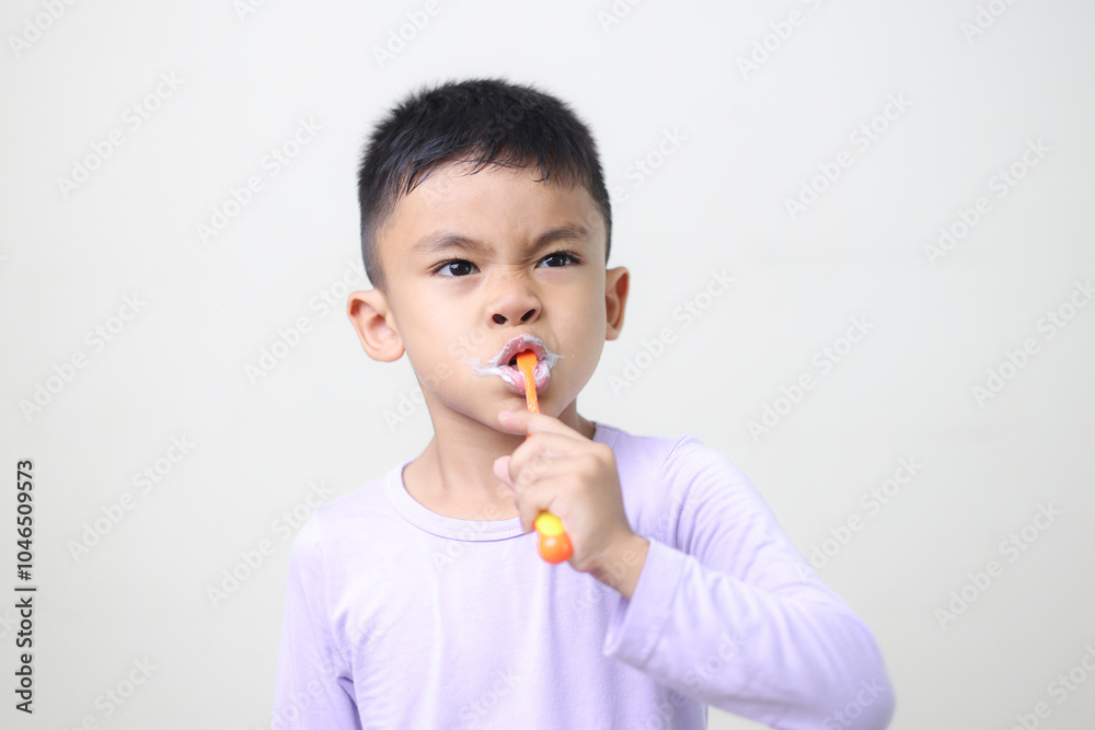 child Asia kid boy brushing teeth isolated on white backgroud.