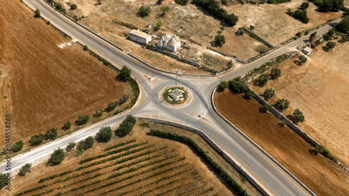 Aerial view of a roundabout with four roads with four exits. Empty road intersection. photo