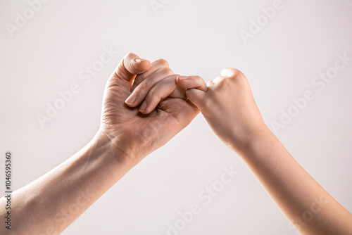 Child hook little finger together. Two hands hook pinky fingers together to promise, swear or asking for reconciled together. Man and woman finger holding together,concept friendship sign