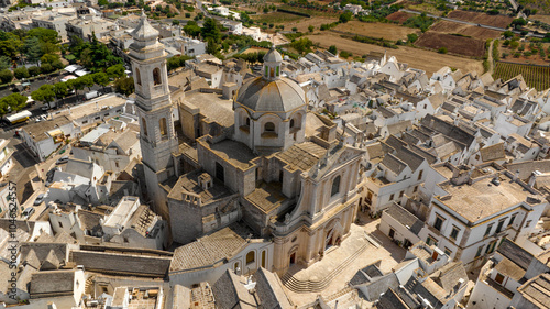 Fototapeta Naklejka Na Ścianę i Meble -  Aerial view of the church of San Giorgio Martire in Locorotondo, in the metropolitan city of Bari, Italy. It is a Catholic church located in the historic center of the town.