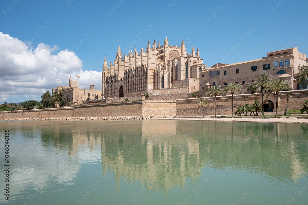 Fototapeta premium Views towards the La Seu Cathedral known locally as Baslica de Santa Mara as seen from the other side of the artificial lake, Parc de la Mar, Palma de Mallorca, Balearic Islands, Spain