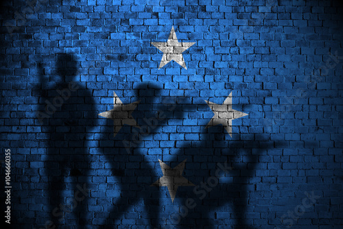 micronesia flag on brick wall and soldiers shadow