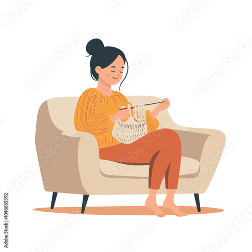 A pregnant woman knitting baby booties on a couch