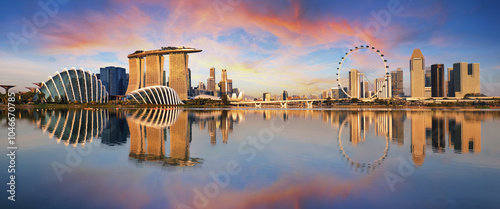 Panorama of Singapore city skyline at business modern downtown building area in sunrise with cloud and sun light and reflection architecture on water