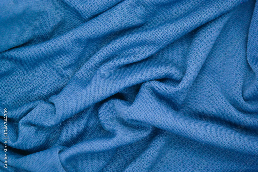 Abstract texture a wrinkled soft blue blanket