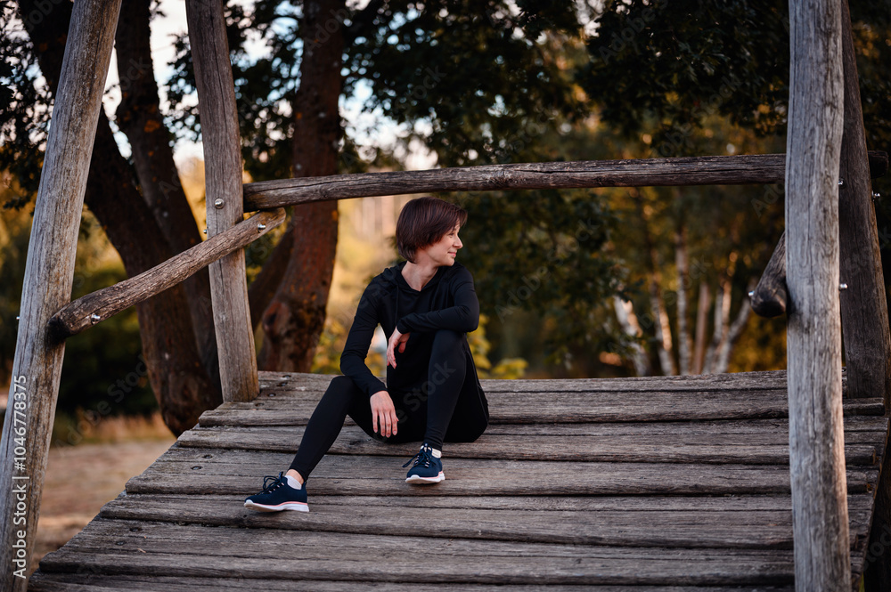 Obraz premium Woman relaxing outdoors on a wooden platform
