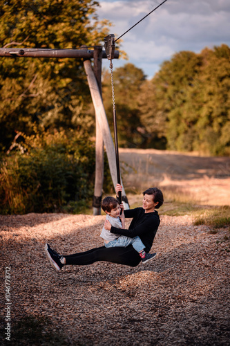 Mother and son enjoying a fun zipline ride outdoors photo