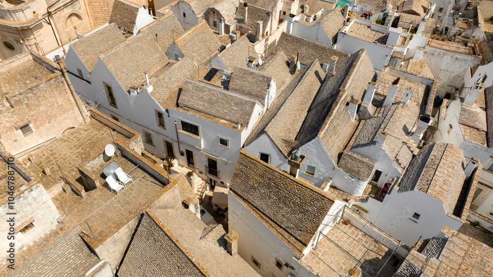 Aerial view of white houses, apartments and buildings in the historic center of Locorotondo, in the metropolitan city of Bari, Italy. Aerial view of white houses, apartments and buildings in the historic center of Locorotondo, in the metropolitan city of Bari, Italy.