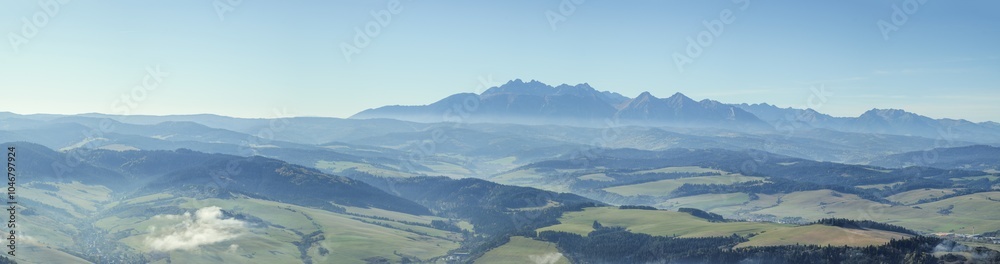 Panorama of the Tatra Mountains seen from the Pieniny Mountains. Long focal length. A beautiful sunny slightly foggy day.