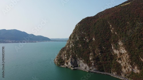 drone reveals iseo lake in north italy flying close to a tock stone formation photo