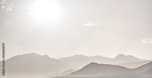 Panoramic minimalist landscape of mountain ranges in Pamir in the Tien Shan Mountains in Tajikistan, silhouette of mountain peaks, landscape for the background photo