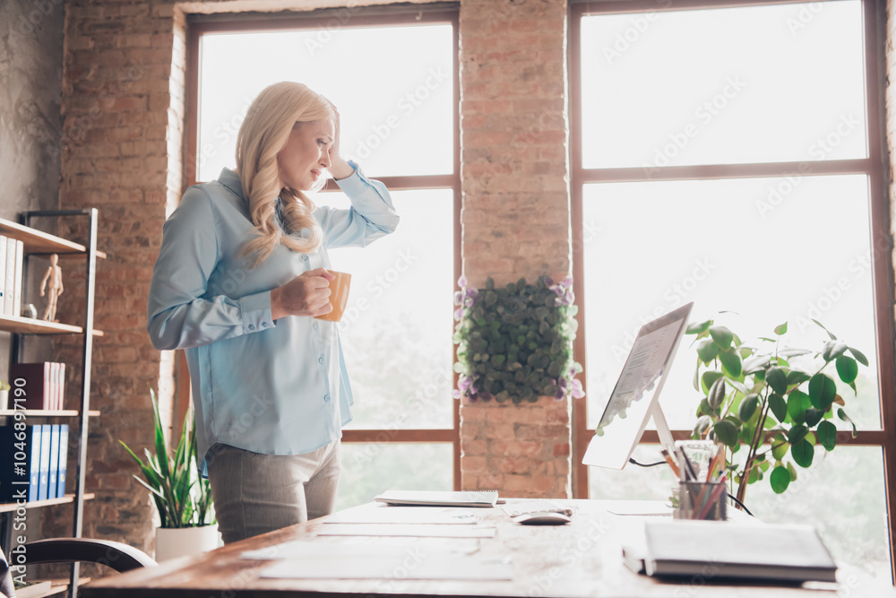 Profile portrait of young business woman sad hold coffee hand touch head wear shirt loft interior business center office indoors