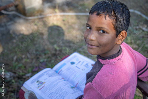 Photography Poor Indian boy sits comfortably in a chair, engrossed in a book, surrounded by greenery