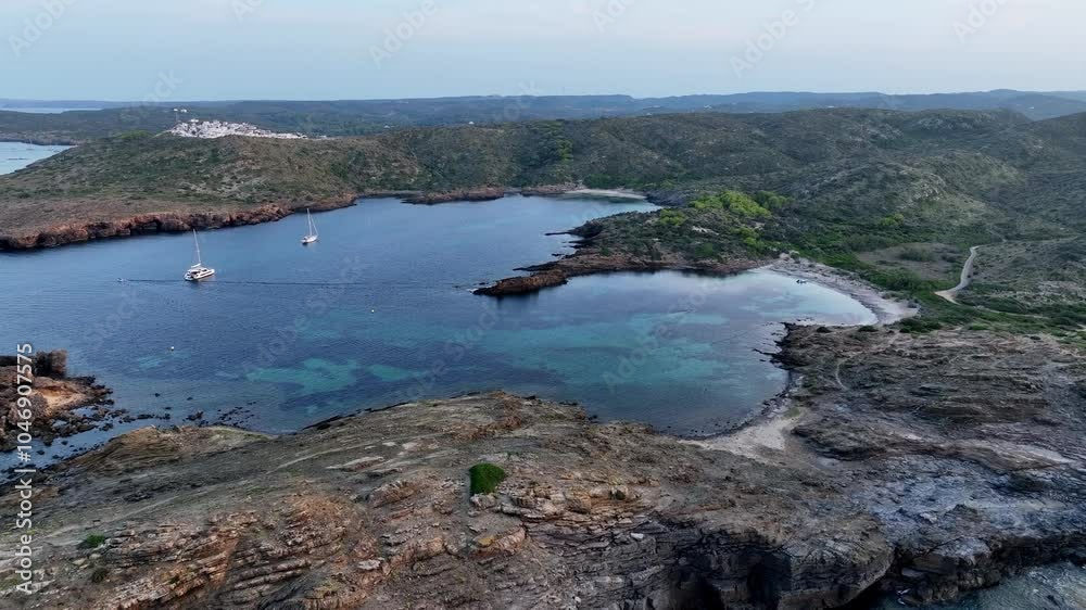 Drone shot backing out and rising when filming a beautiful piece of nature on Menorca with one of them medieval guard towers. Drone shot backing out and rising when filming a beautiful piece of nature on Menorca with one of them medieval guard towers.