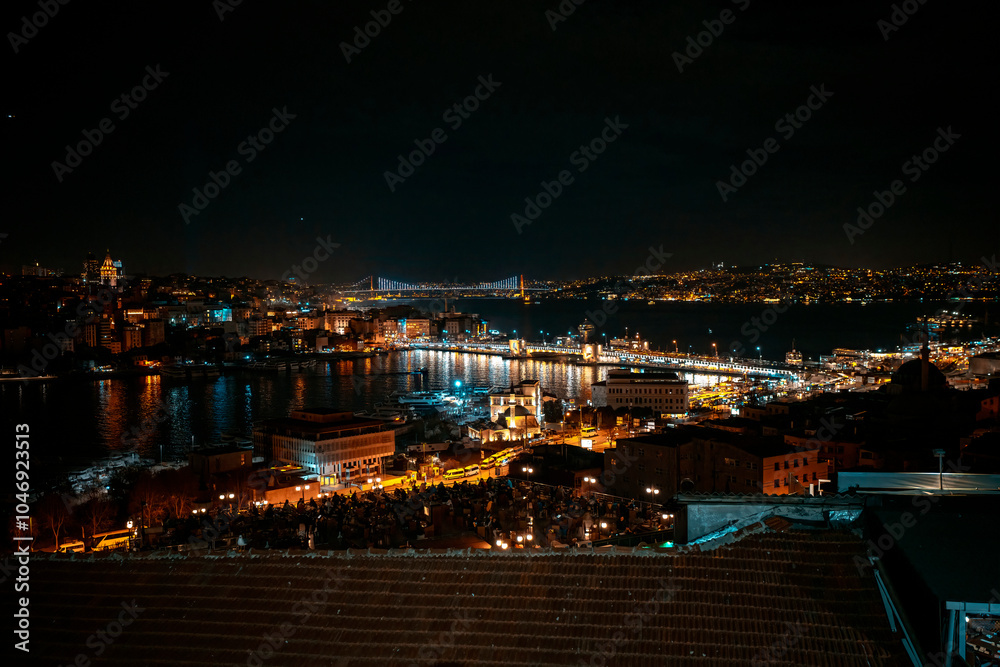 Fototapeta premium Night view of the Golden Horn Bridge. July 15 Martyrs Bridge in the background. Photo taken from a high area. Galata Tower. Wide angle view of Istanbul.