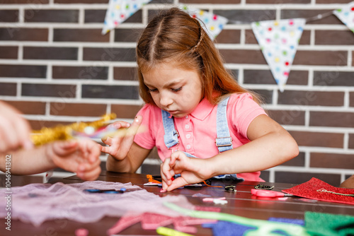 Cute preschooler girl makes art at a summer outdoor party