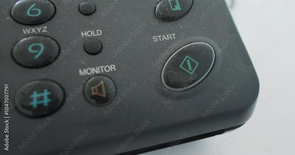 Close-up, finger pressing the start button on an old fax, analog transmission of information. Concept of launching and using old equipment. Close-up, finger pressing the start button on an old fax, analog transmission of information. Concept of launching and using old equipment.