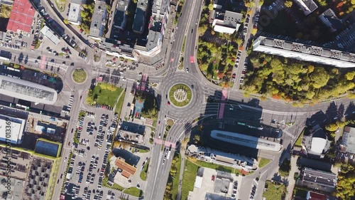 4K aerial shot of the city urban area in Brasov, Romania. Main road, circle with trafiic. View of the roofs. photo