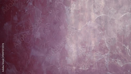 Wall with beautiful red Venetian plaster with characteristic texture, pattern structure and light reflections from the window. Shot in motion