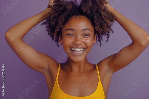 Joyful African American Teenage Girl Getting on Her Toes on Purple Background; Stylish Preteen Girl Fooling Around and Laughing Out Loud - Full Height Banner photo