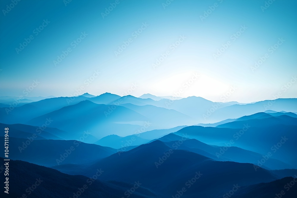 Naklejka premium Misty mountain range under soft blue twilight skies in summer