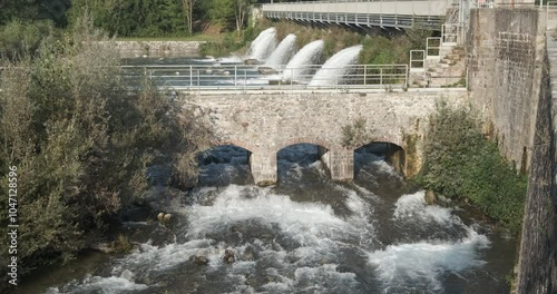 Water jets. Rough river waters.Water rushes furiously at the exit of a power plant. Italy