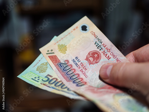 Vietnamese Dong Currency Notes in Hand