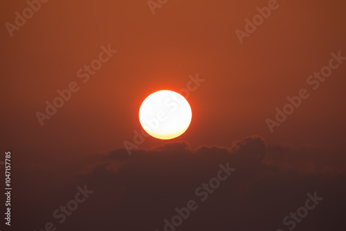 Fototapeta Naklejka Na Ścianę i Meble -  Closeup of bright big sun on the sky with yellow orange gradient colors during the sunset