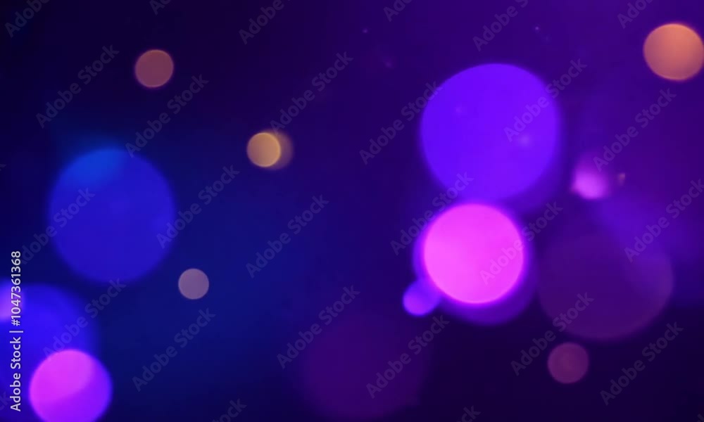 Abstract glowing bokeh lights with blue and purple orbs floating on a dark background, creating a dreamy effect