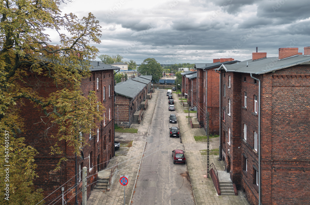 Old residential red brick houses built for railroad workers on Krótka street in Krzyż Wielkopolski, Poland. Autumn view