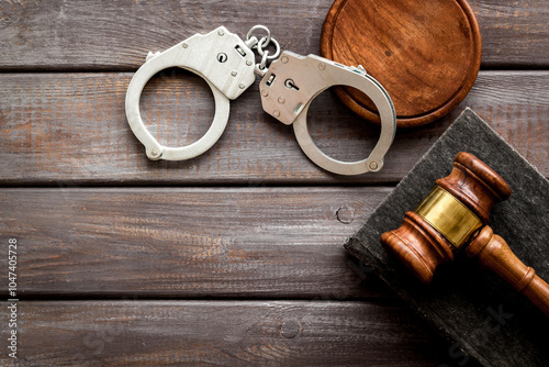 Foto Metal handcuffs with judges gavel and criminal code book